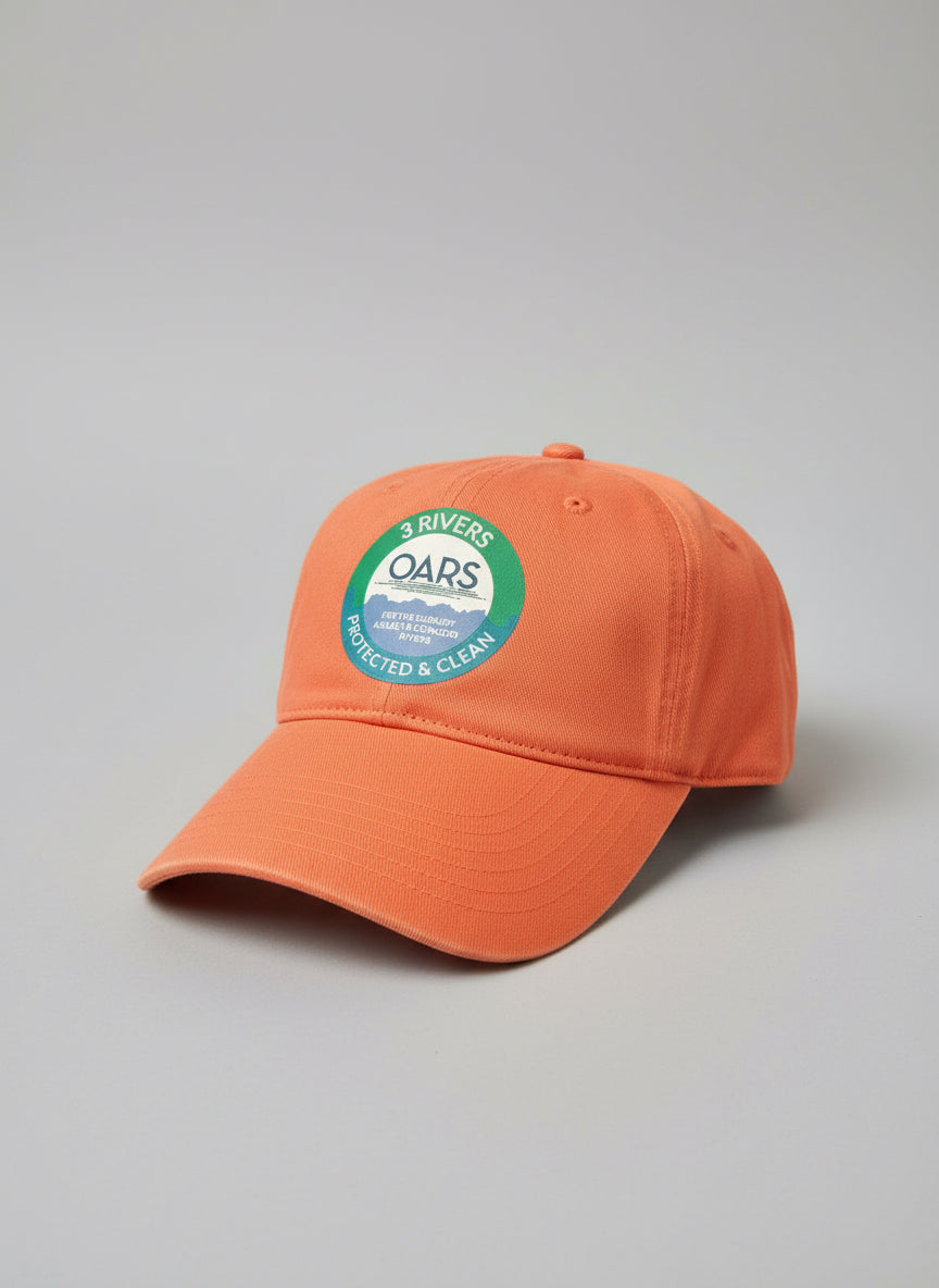 Orange cap with a '3 Rivers OARS' logo on a grass background