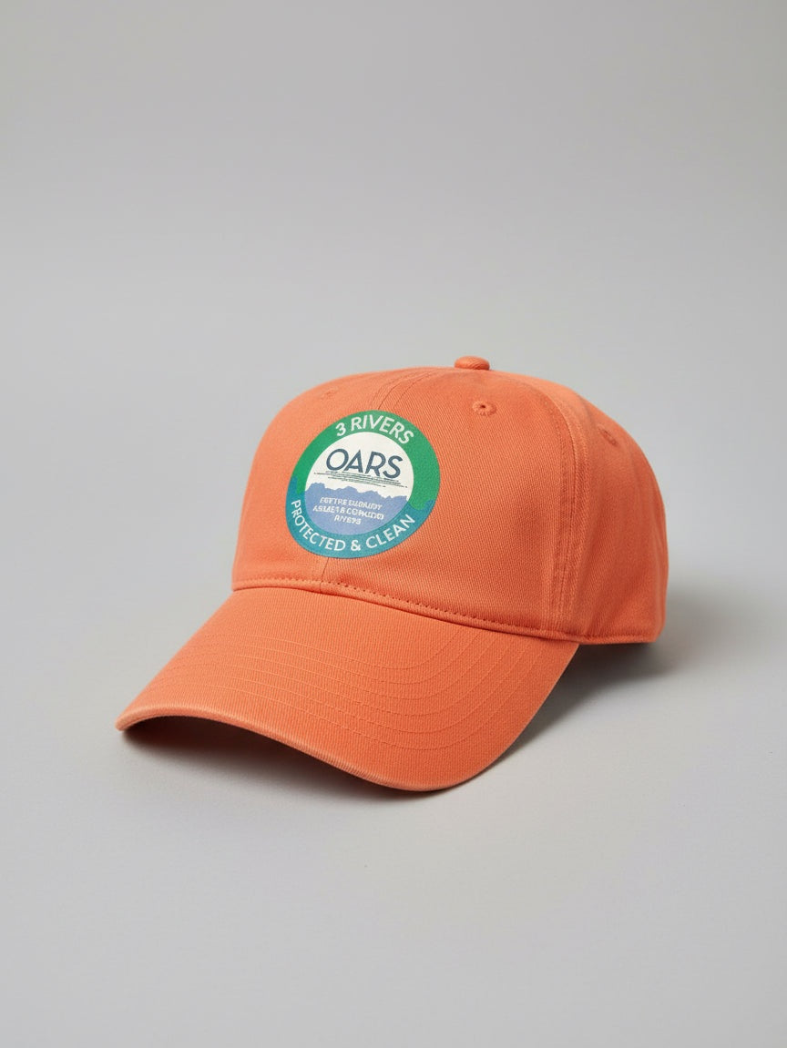 Orange cap with a '3 Rivers OARS' logo on a grass background