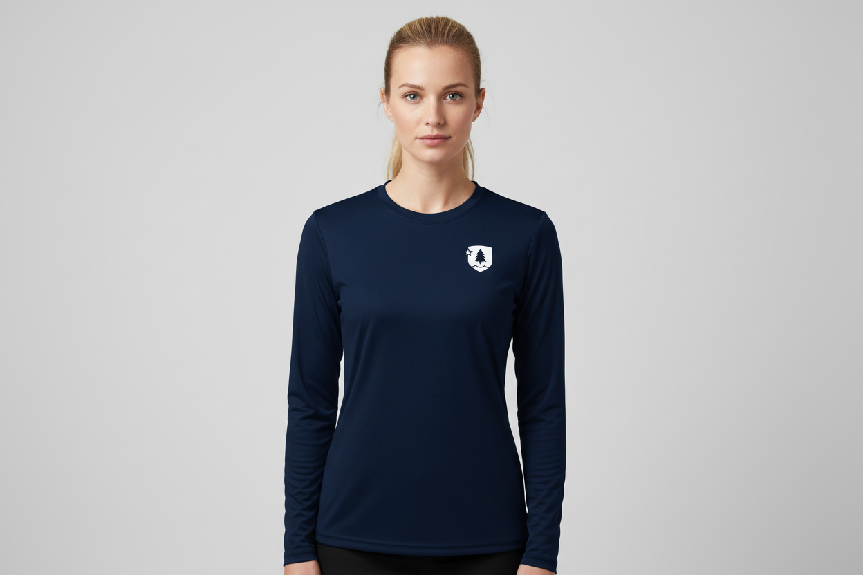 Woman wearing a navy long-sleeve shirt with a logo on a gray background