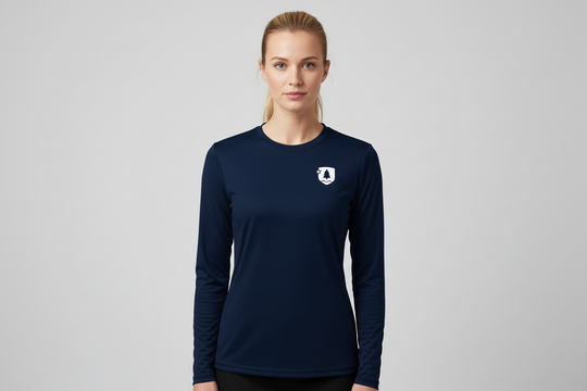 Woman wearing a navy long-sleeve shirt with a logo on a gray background