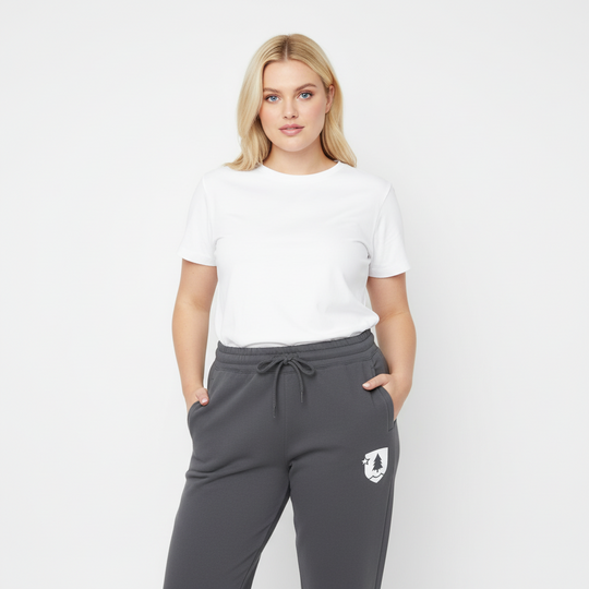 Woman wearing a white t-shirt and gray sweatpants with a logo on a white background