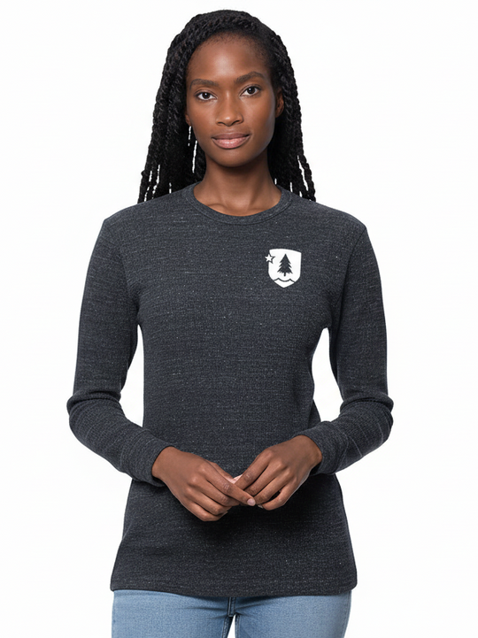 A person wearing a long-sleeved, gray thermal shirt with a small logo on the upper left chest area.